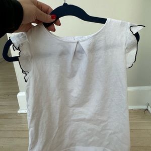 White Jacardi girls top with flutter sleeves navy trim